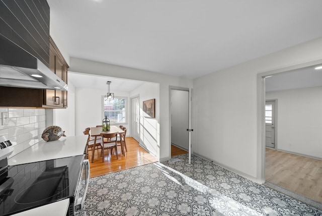 dining area featuring baseboards and light wood-style floors