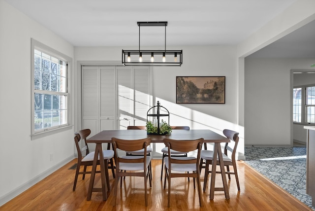 dining area with wood finished floors and baseboards