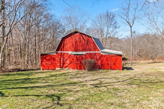 view of barn with a lawn