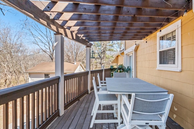 wooden deck featuring outdoor dining space and a pergola