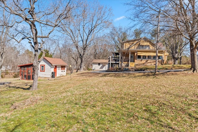 view of yard featuring covered porch, exterior structure, and an outdoor structure