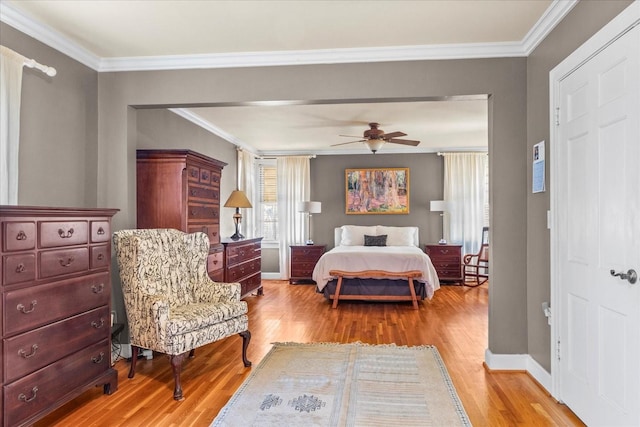 bedroom with light wood-type flooring, baseboards, and crown molding