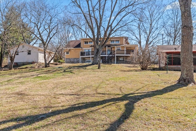 exterior space with stone siding, a lawn, and stairs