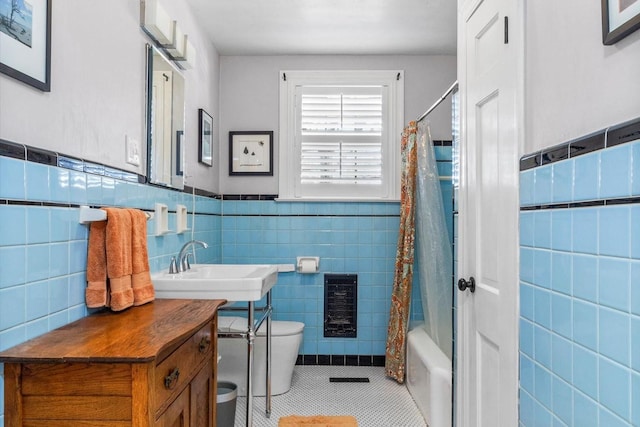 full bathroom featuring tile patterned flooring, shower / bathtub combination with curtain, tile walls, and toilet