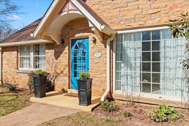 doorway to property with stone siding