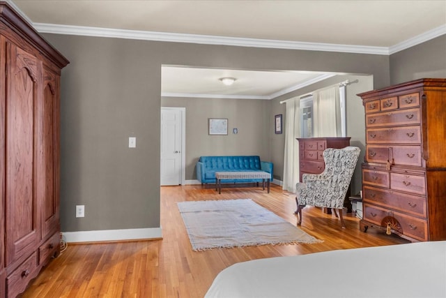 sitting room featuring ornamental molding, wood finished floors, and baseboards