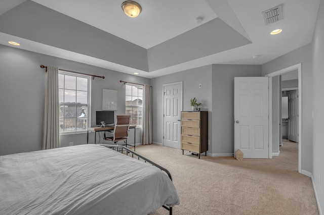 carpeted bedroom featuring baseboards, visible vents, a tray ceiling, and recessed lighting