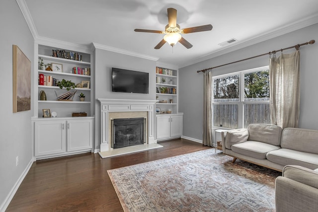 living room featuring dark wood-style flooring, visible vents, ornamental molding, a high end fireplace, and baseboards