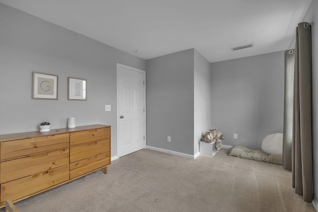 bedroom with carpet floors, visible vents, and baseboards