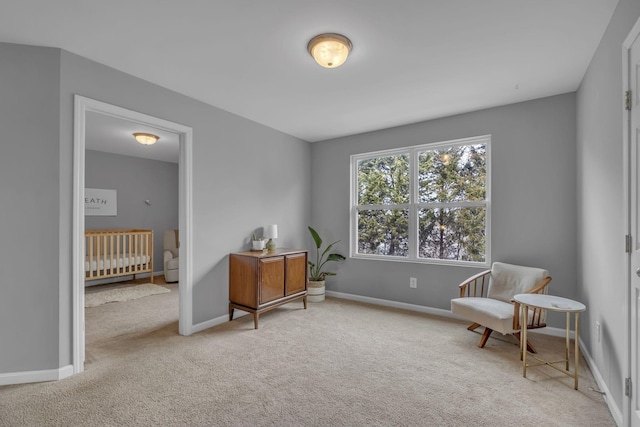 living area featuring carpet floors and baseboards