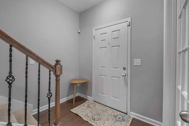 entryway featuring stairs, dark wood finished floors, and baseboards