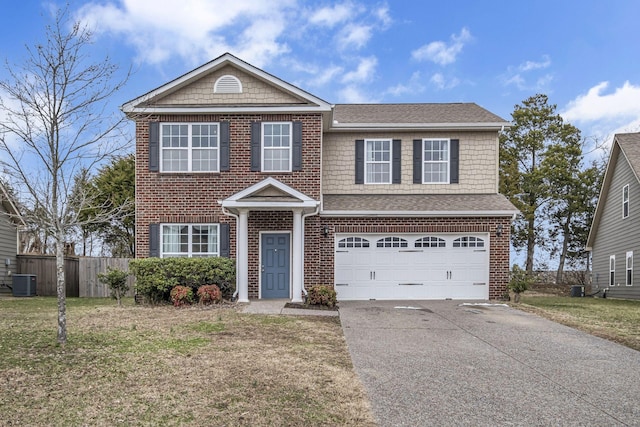 traditional-style home with concrete driveway, an attached garage, fence, cooling unit, and a front lawn