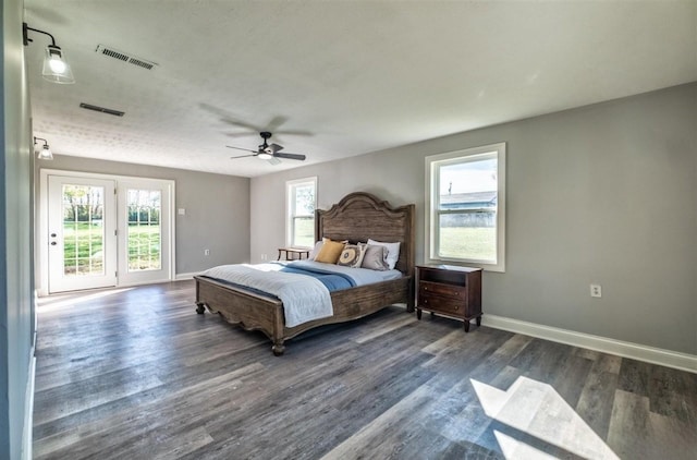 bedroom with baseboards, access to outside, visible vents, and wood finished floors