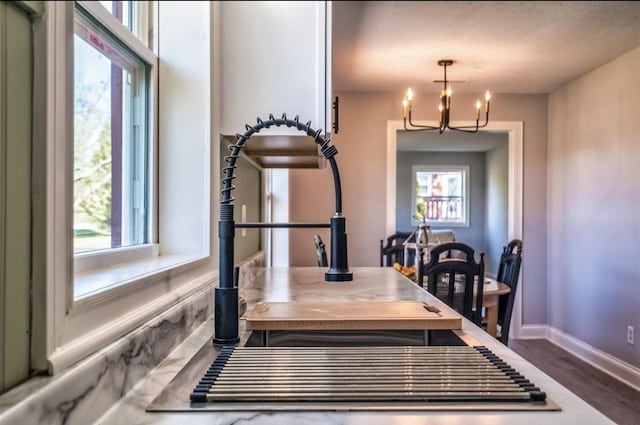 interior details with baseboards, a notable chandelier, and decorative light fixtures