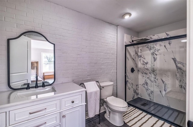 bathroom featuring toilet, brick wall, wood finished floors, vanity, and a marble finish shower