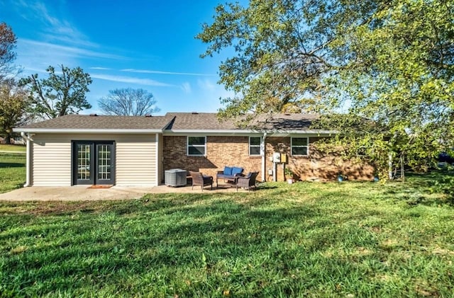 rear view of property with a yard, central AC, a patio, and brick siding