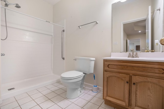 bathroom with baseboards, toilet, tile patterned flooring, a tile shower, and vanity