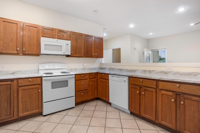 kitchen featuring brown cabinetry, recessed lighting, white appliances, and light tile patterned floors