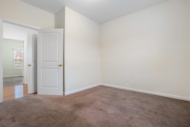 spare room with carpet floors and baseboards