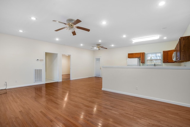 unfurnished living room featuring baseboards, recessed lighting, visible vents, and light wood-style floors