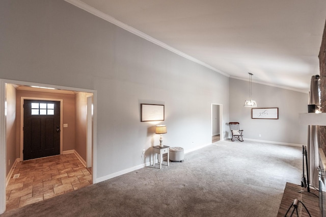 carpeted foyer with high vaulted ceiling, ornamental molding, and baseboards