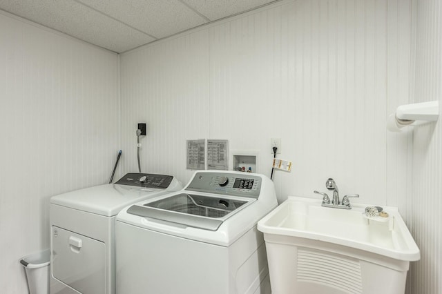 laundry area featuring laundry area, separate washer and dryer, and a sink