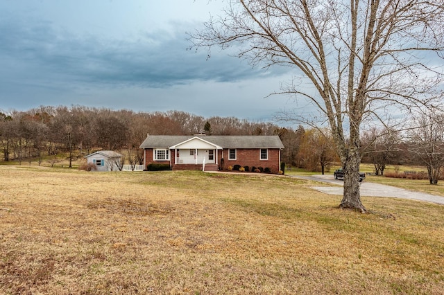 view of front of house with brick siding and a front yard