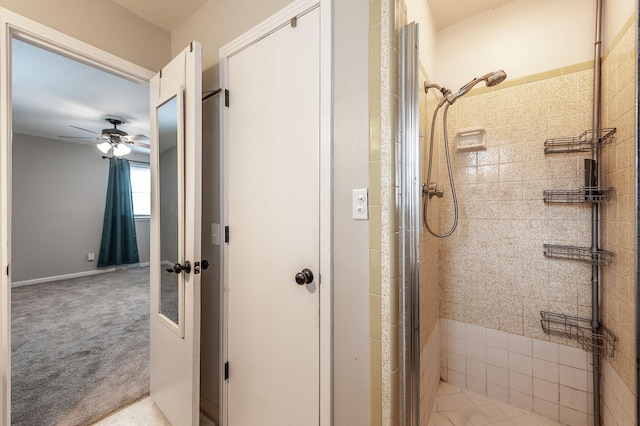 full bathroom featuring a shower stall and a ceiling fan