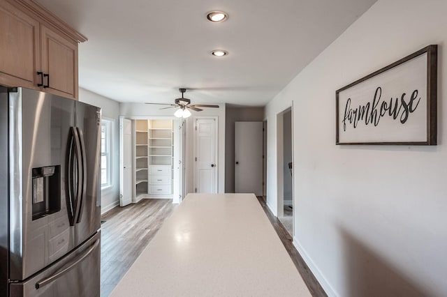 kitchen with baseboards, ceiling fan, stainless steel fridge with ice dispenser, and wood finished floors