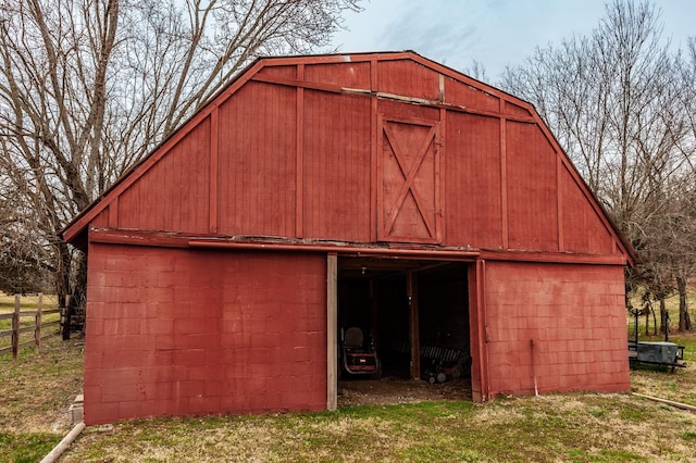 view of barn with fence