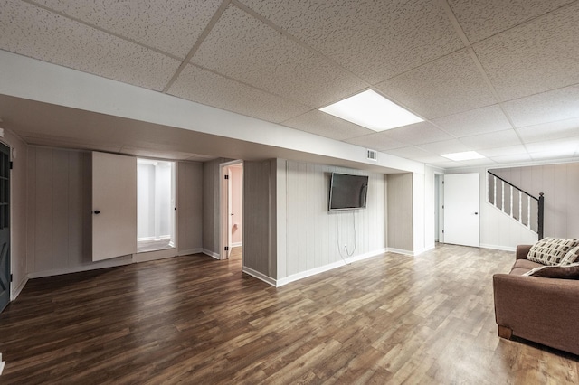 interior space featuring stairs, a paneled ceiling, wood finished floors, and visible vents