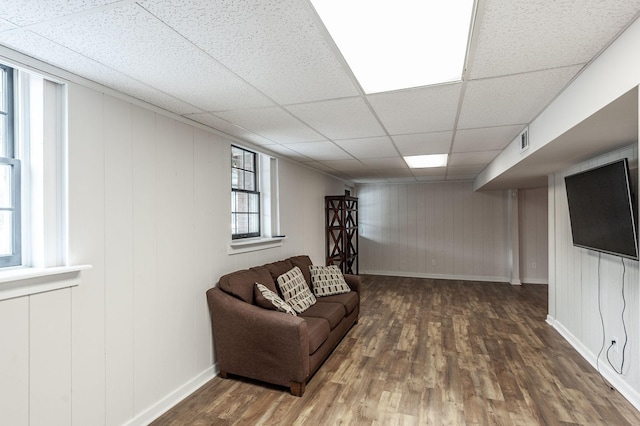 sitting room featuring a paneled ceiling, visible vents, baseboards, and wood finished floors