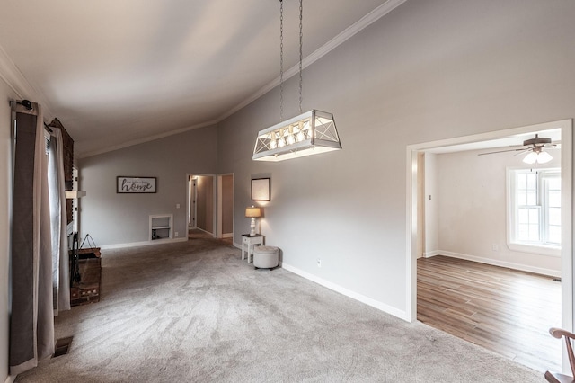 interior space featuring high vaulted ceiling, carpet floors, visible vents, baseboards, and ornamental molding