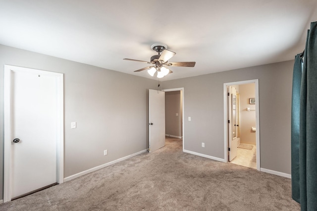 unfurnished bedroom with a ceiling fan, carpet, connected bathroom, and baseboards