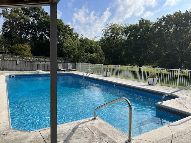 view of swimming pool featuring a patio area, fence, and a fenced in pool