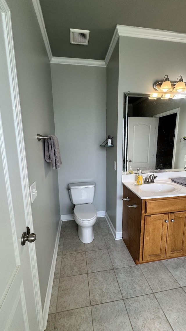 half bath with toilet, vanity, visible vents, ornamental molding, and tile patterned floors