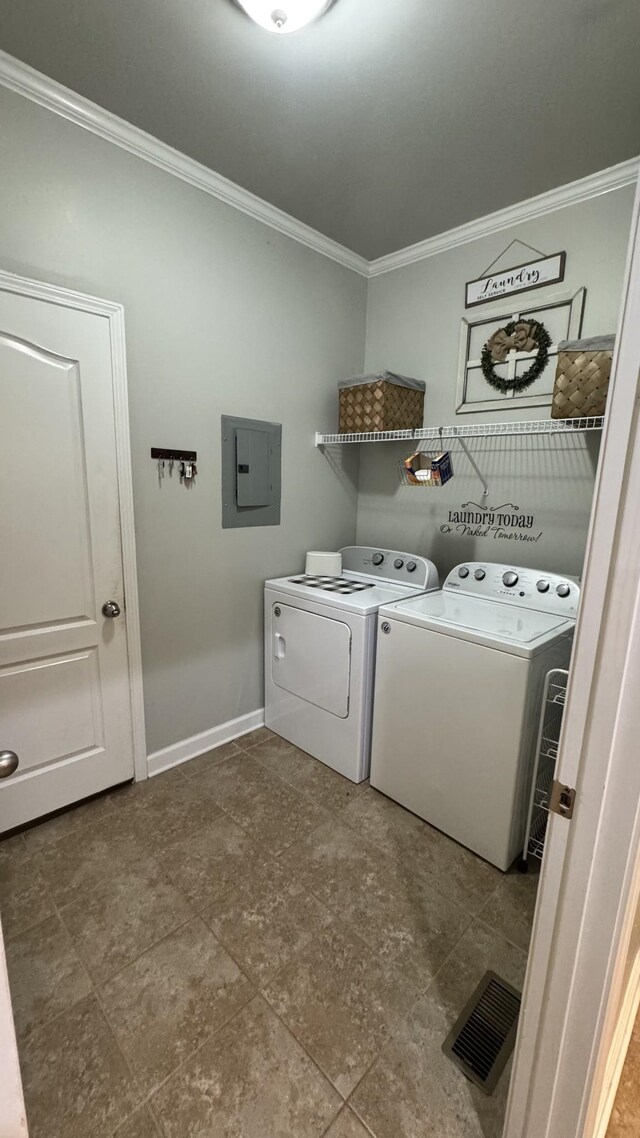 clothes washing area featuring ornamental molding, washing machine and dryer, laundry area, electric panel, and baseboards