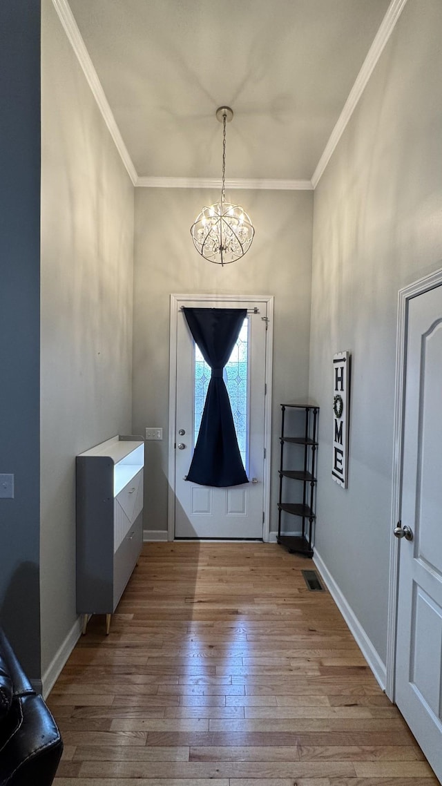 entrance foyer featuring crown molding, baseboards, and hardwood / wood-style flooring