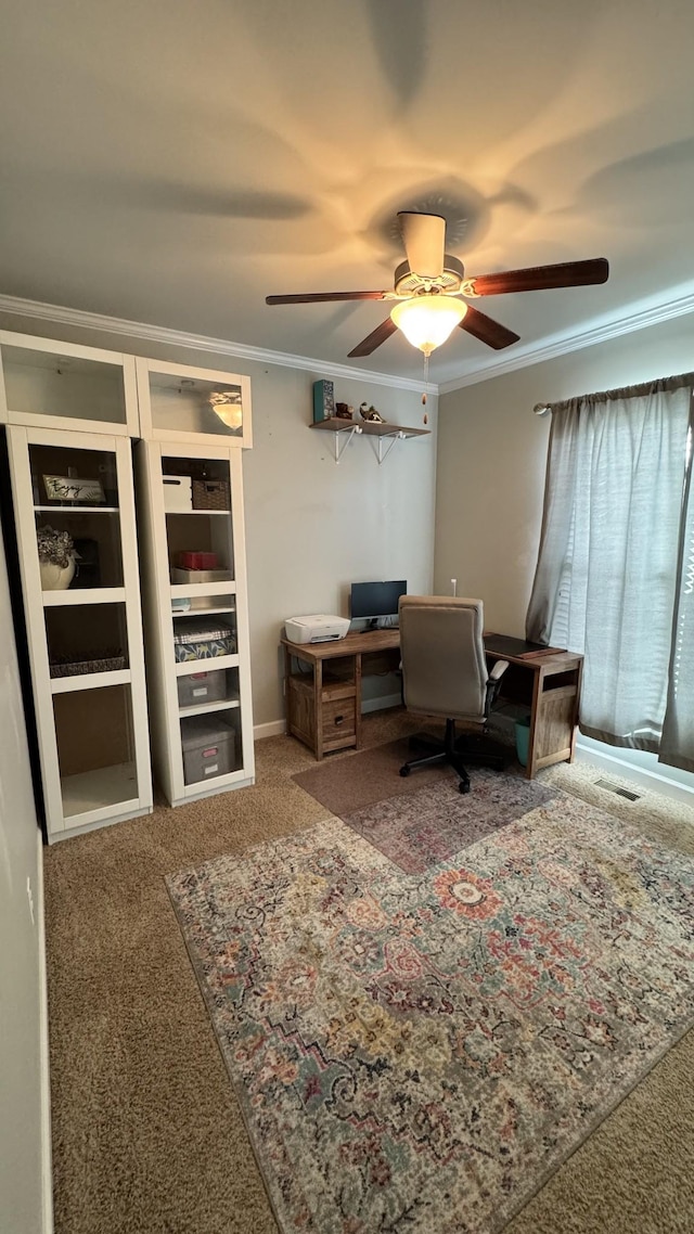 carpeted office with visible vents, a ceiling fan, and crown molding