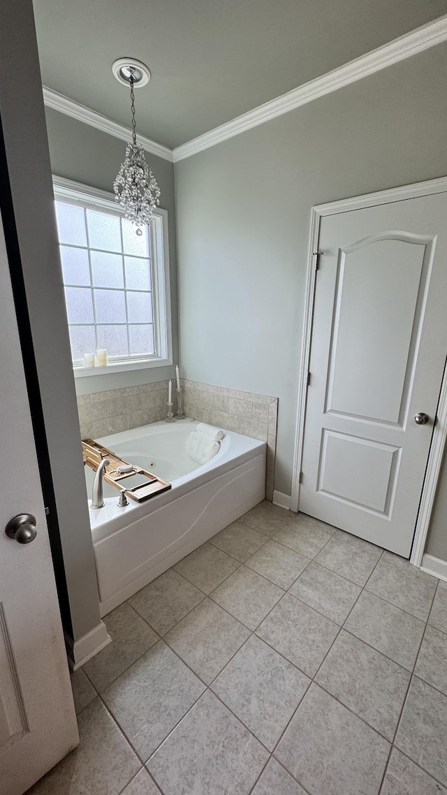 bathroom with ornamental molding, tile patterned flooring, a garden tub, and baseboards