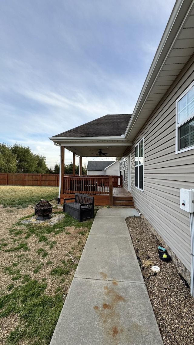 view of patio with an outdoor fire pit, fence, and a wooden deck