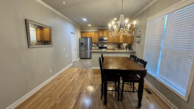 dining space featuring light wood-type flooring and baseboards