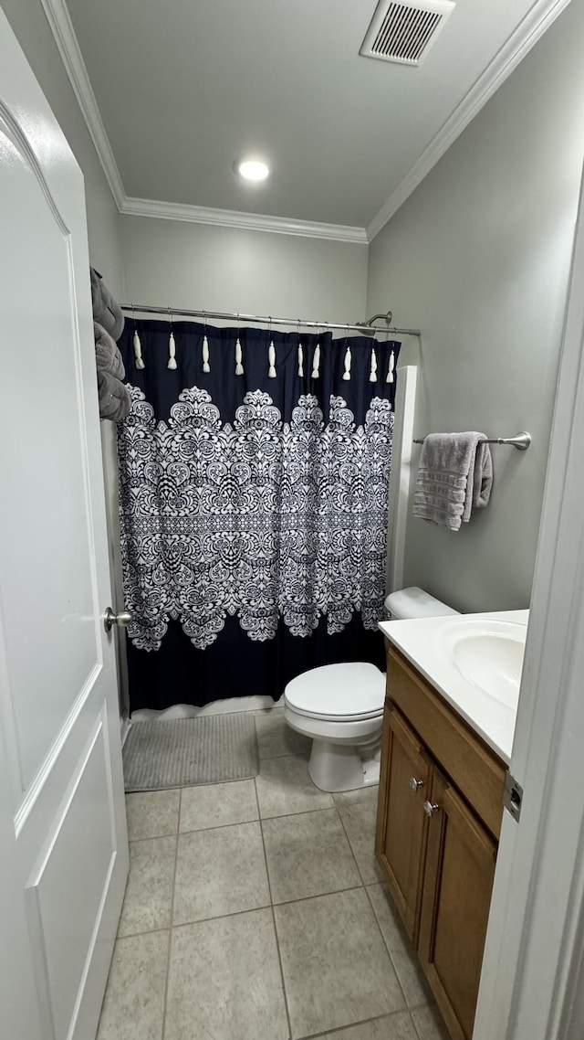 full bath featuring toilet, vanity, visible vents, ornamental molding, and tile patterned floors