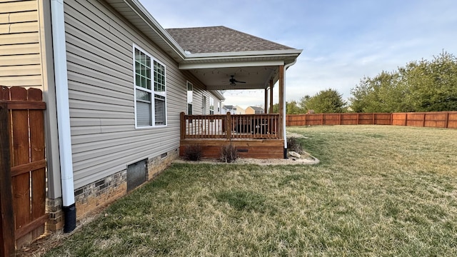 view of yard with a ceiling fan and fence