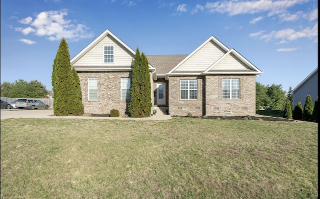 view of front of house featuring crawl space, driveway, brick siding, and a front yard