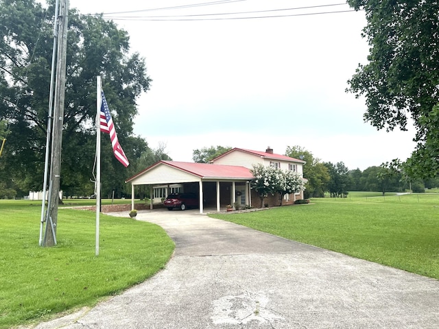 view of community featuring driveway and a yard