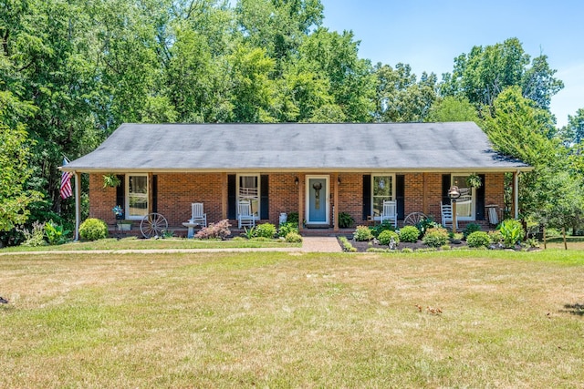 ranch-style house featuring a porch, a front yard, and brick siding