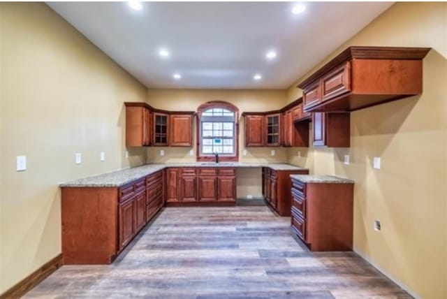 1319 Cemetery Rd, Auburn, KY 42206 - kitchen with baseboards, glass insert cabinets, wood finished floors, light stone countertops, and recessed lighting