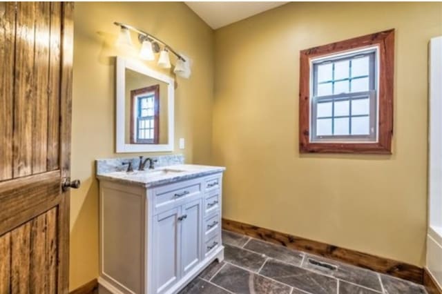 1319 Cemetery Rd, Auburn, KY 42206 - bathroom featuring stone finish floor, vanity, and baseboards