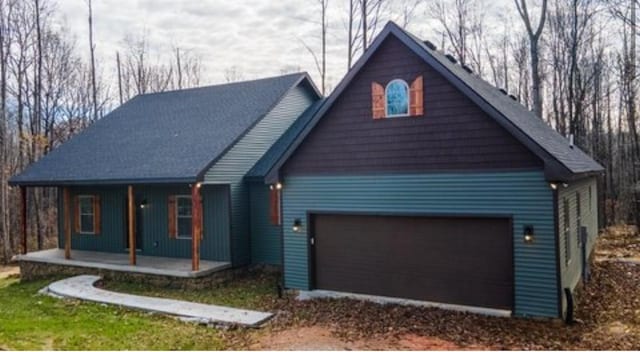 1319 Cemetery Rd, Auburn, KY 42206 - view of front facade featuring covered porch, dirt driveway, and a garage